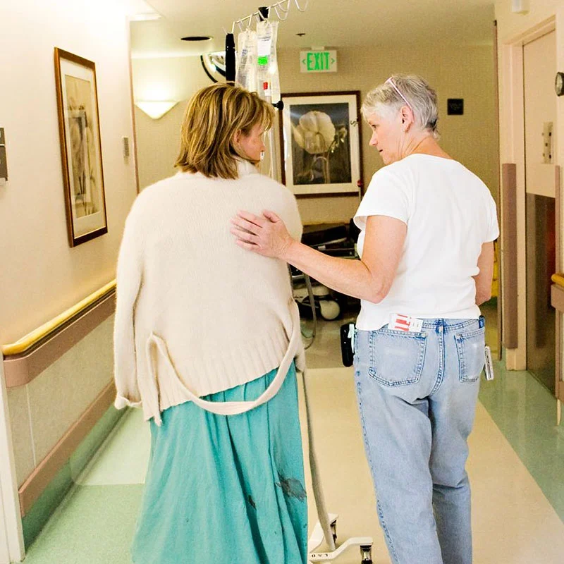 Birth doula, tracy hartley, walking with a pregnant client in the hospital corridor.