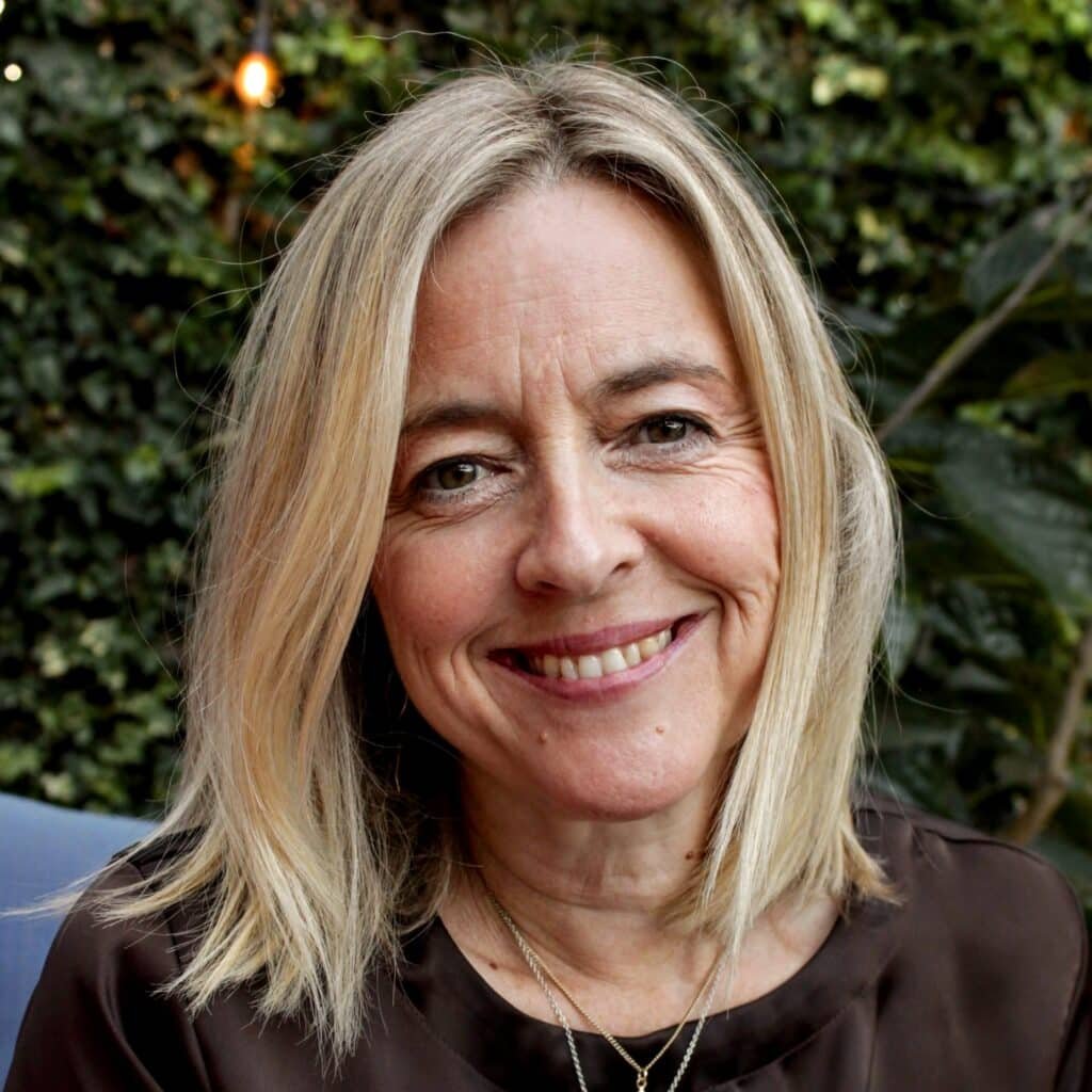 Photo of doula Harriet, blond woman smiling at the camera