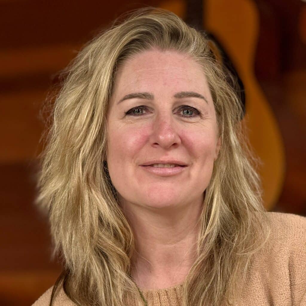 Photo of a doula, a woman with blond hair looking into the camera