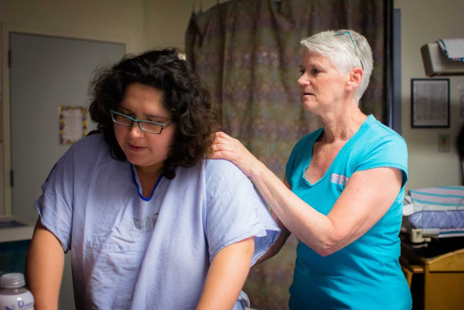 A doula supporting a laboring woman at the hospital.