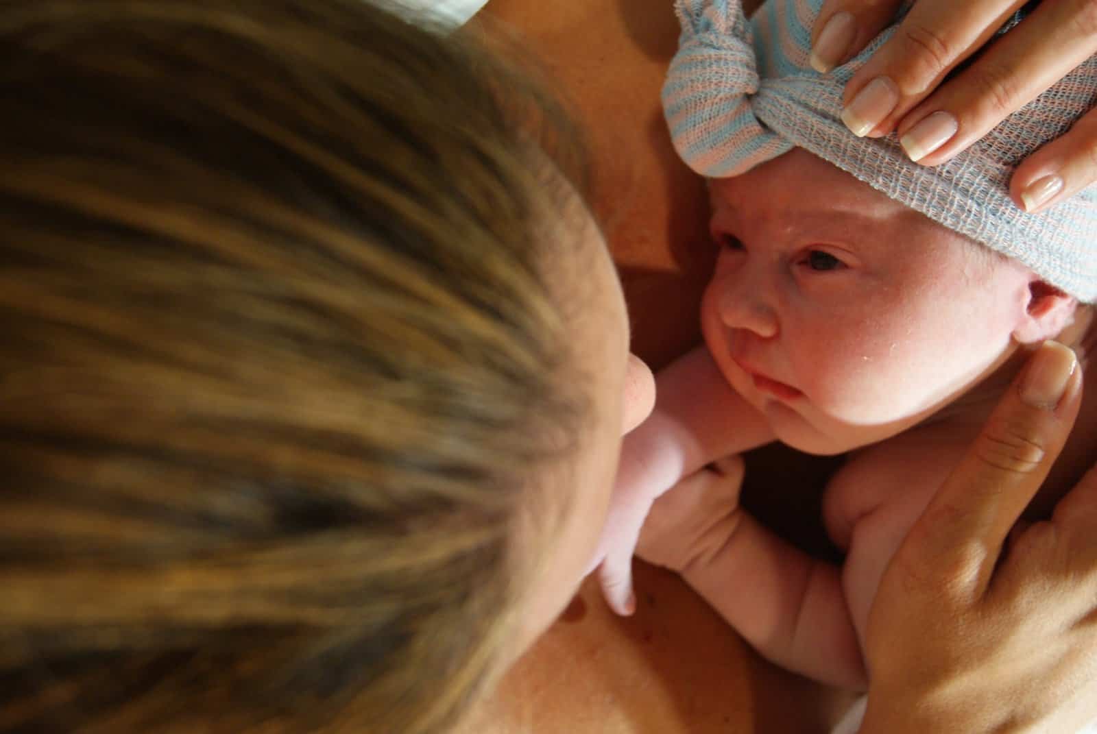 Mother and baby gazing into each others eyes after birth.